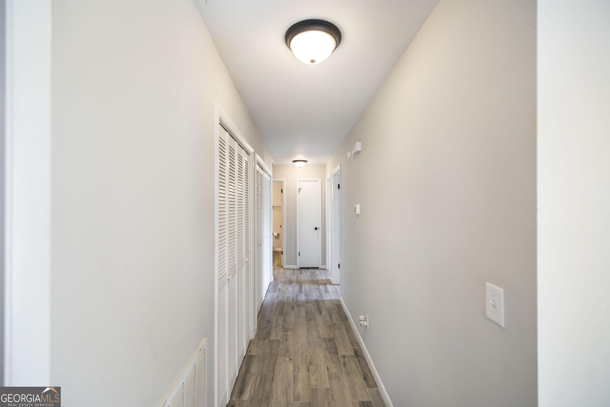 221 Gilchrist Drive Warner Robins, GA 31093 - Photo 15 of 33 a view of a hallway with wooden floor