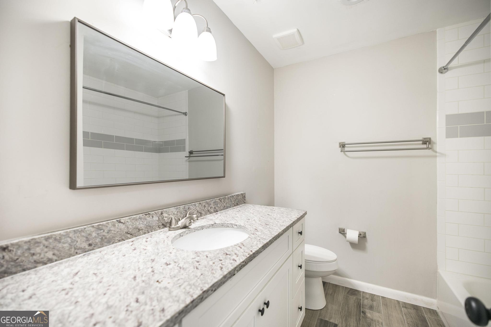 221 Gilchrist Drive Warner Robins, GA 31093 - Photo 18 of 33 a bathroom with a granite countertop sink and a mirror