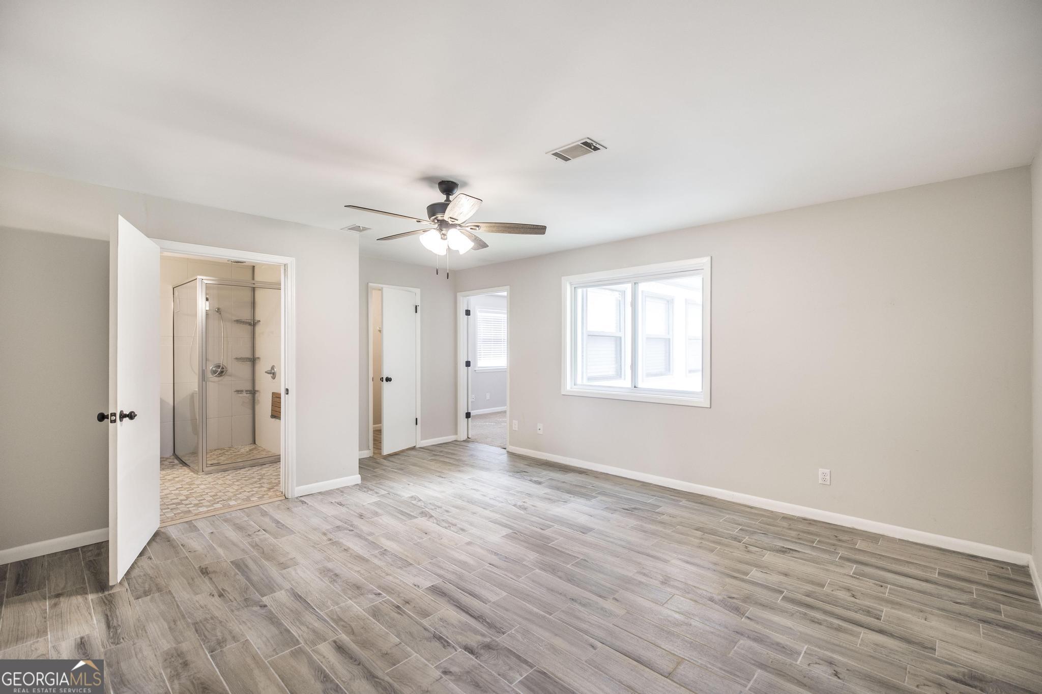 221 Gilchrist Drive Warner Robins, GA 31093 - Photo 21 of 33 a view of an empty room with wooden floor