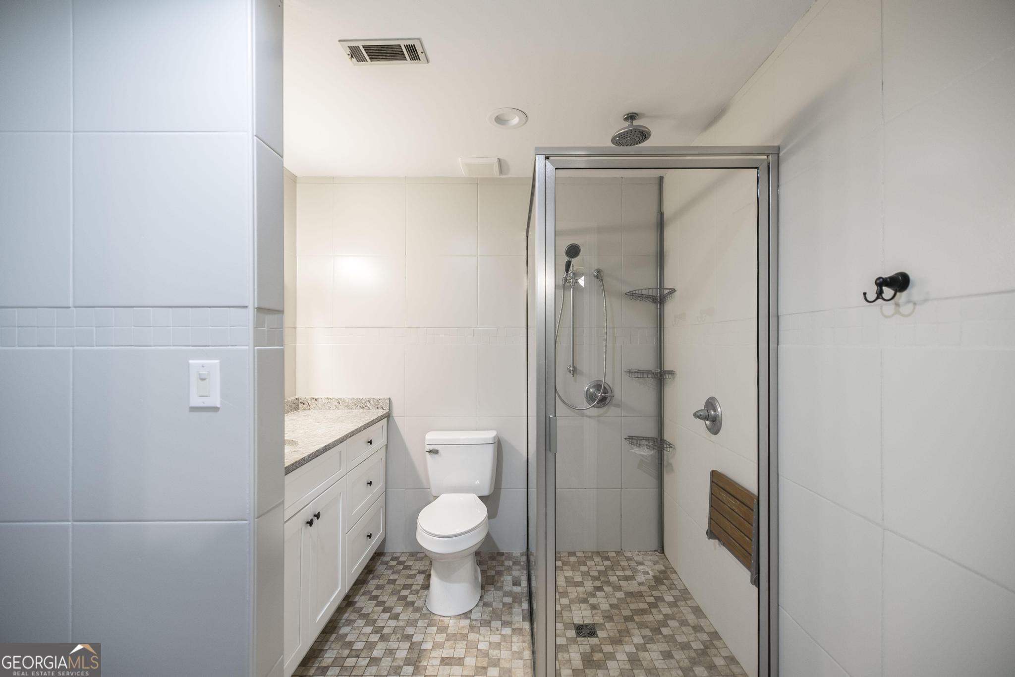 221 Gilchrist Drive Warner Robins, GA 31093 - Photo 23 of 33 a bathroom with a granite countertop shower and a toilet