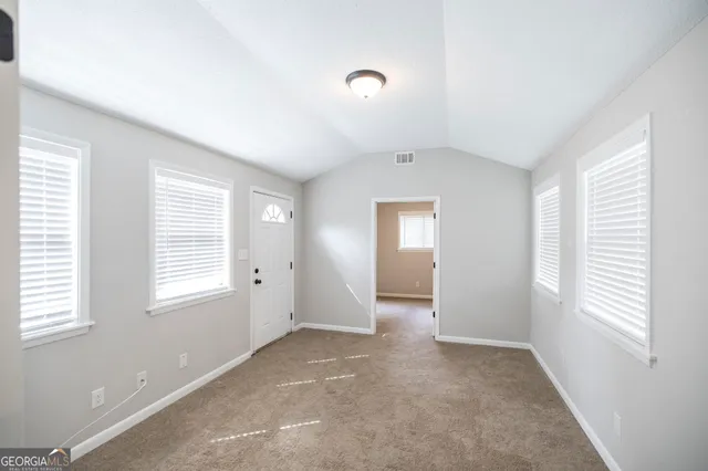 a view of an empty room with a window