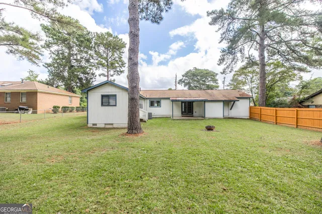 a front view of a house with a garden and yard