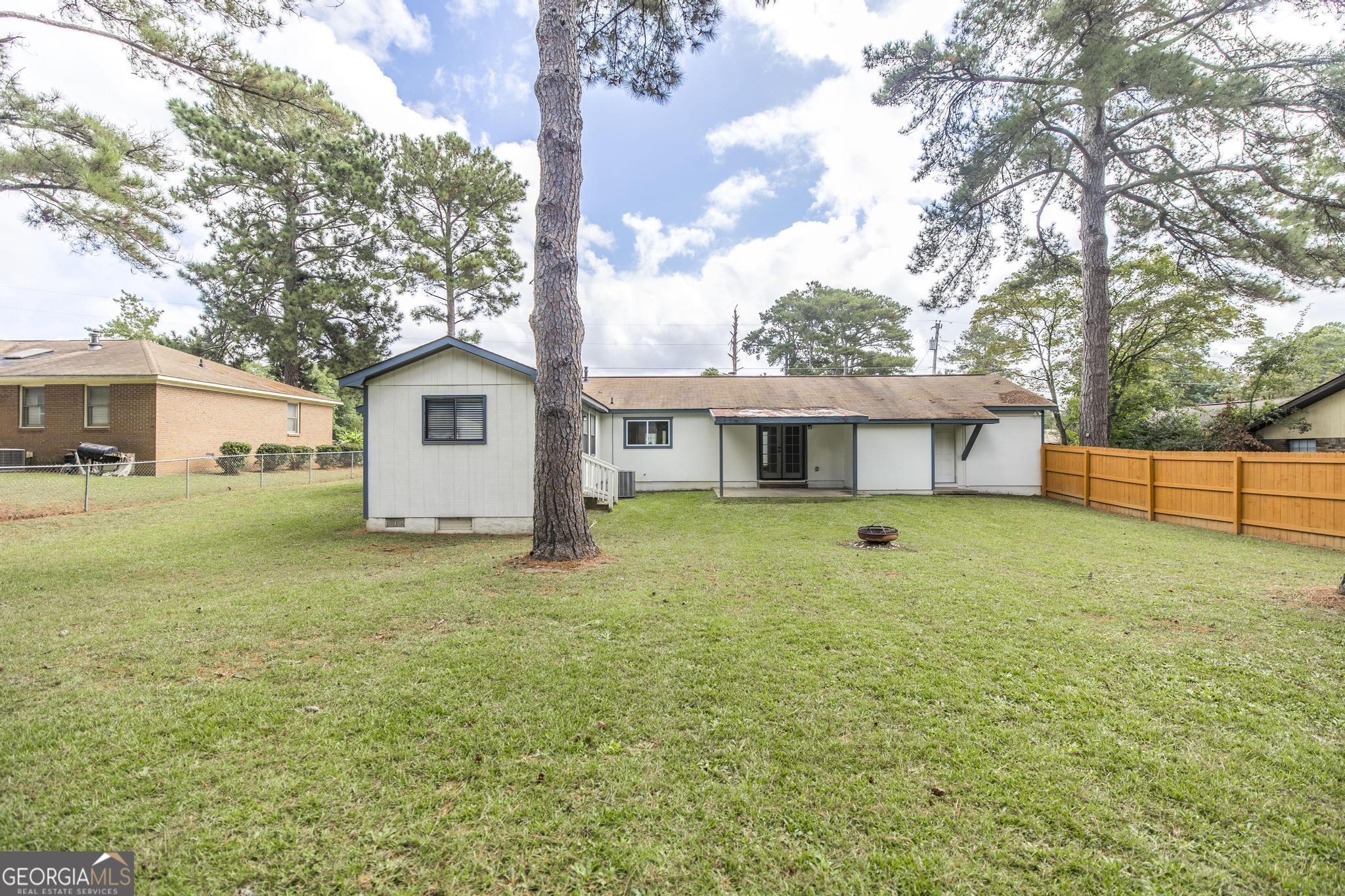 221 Gilchrist Drive Warner Robins, GA 31093 - Photo 29 of 33 a front view of a house with a garden and yard