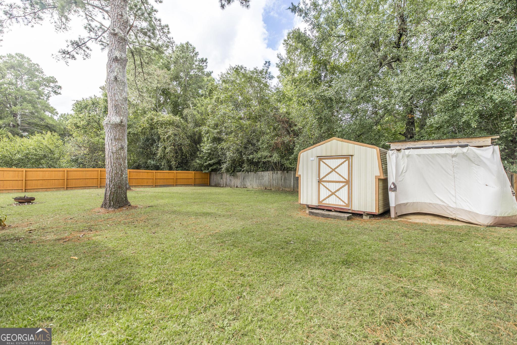 221 Gilchrist Drive Warner Robins, GA 31093 - Photo 31 of 33 a view of a field with large trees