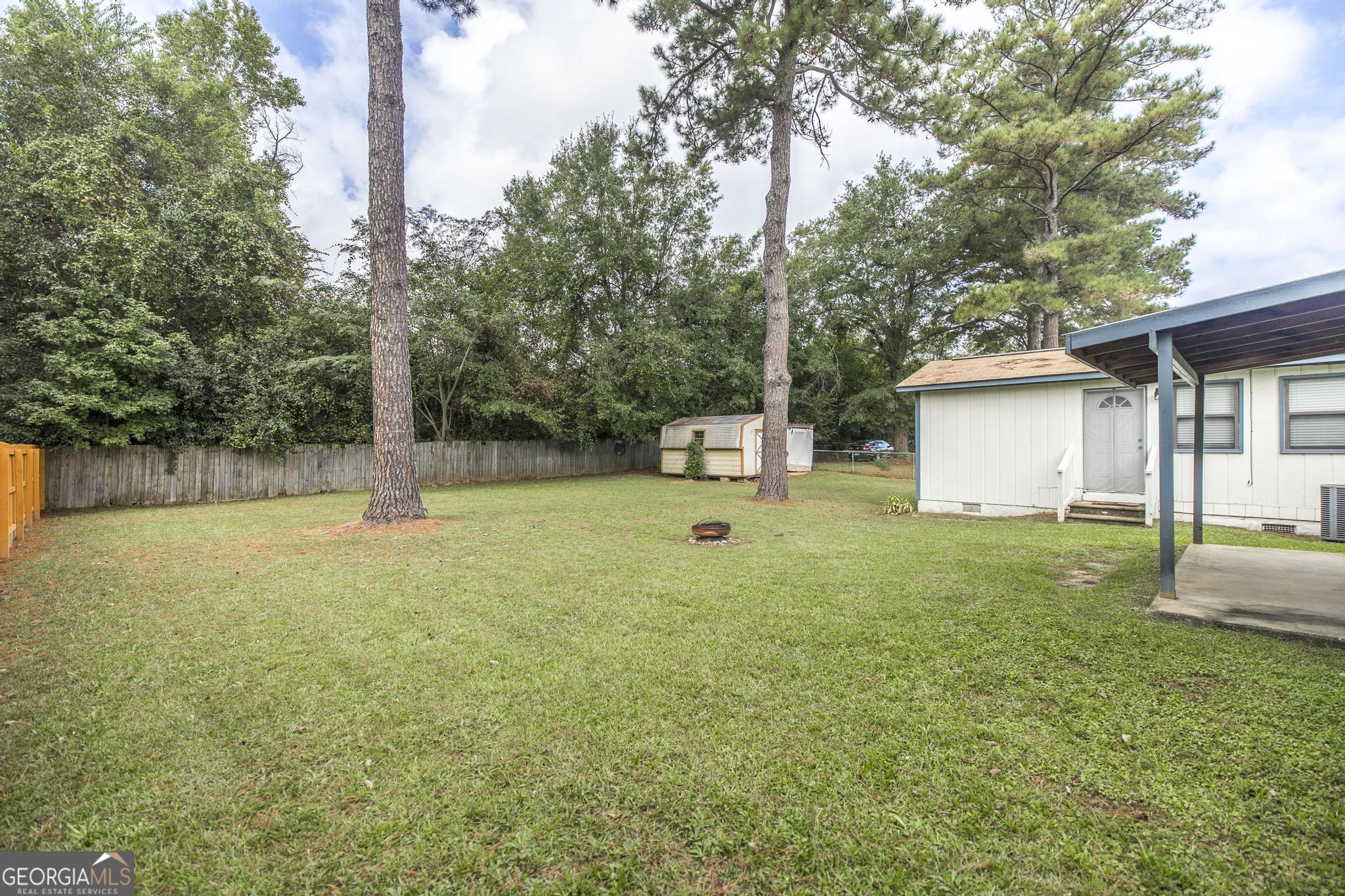 221 Gilchrist Drive Warner Robins, GA 31093 - Photo 33 of 33 a backyard of a house with lots of green space