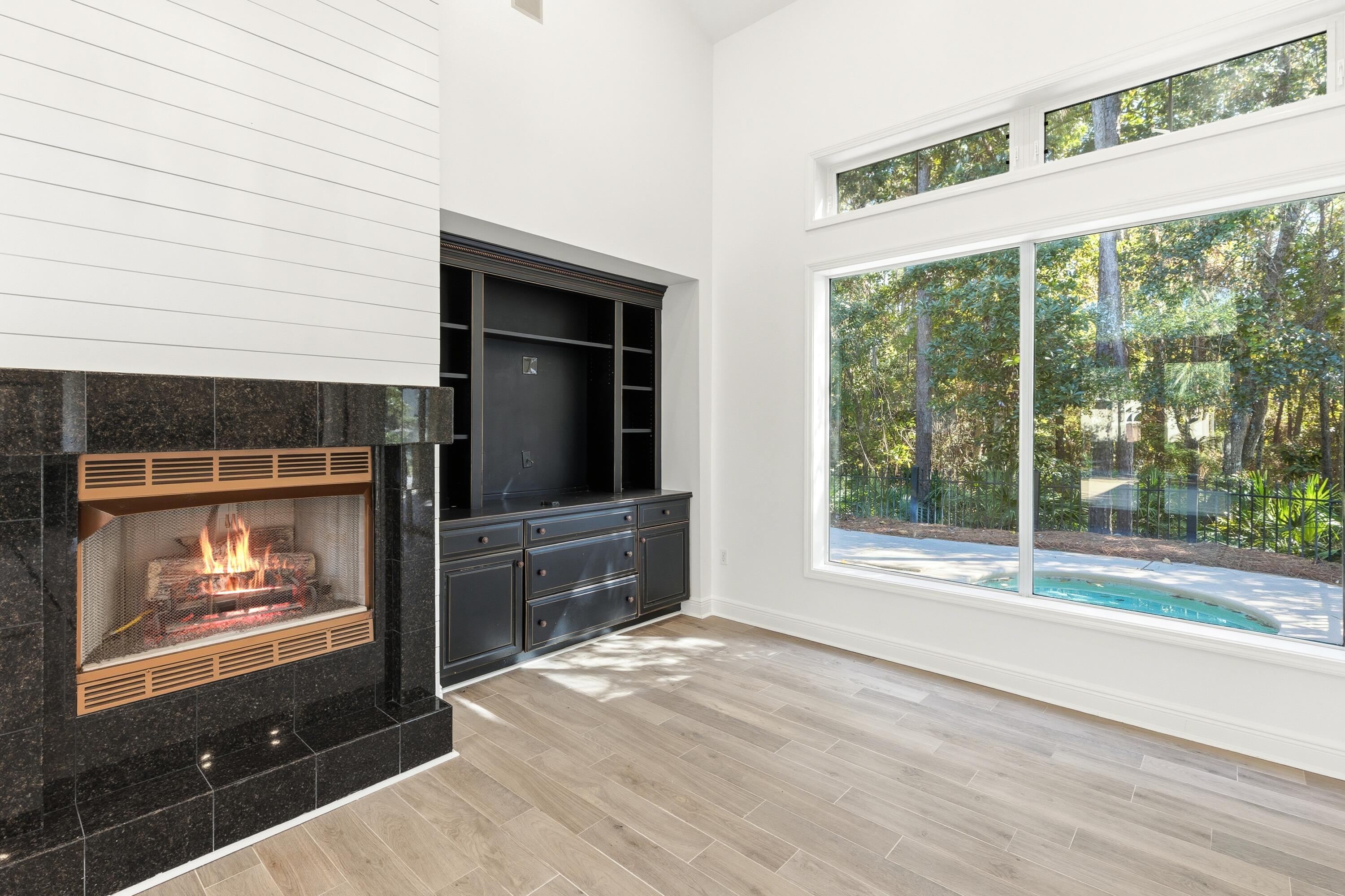 2928 Pine Valley Road Miramar Beach, FL 32550 - Photo 13 of 76 a view of empty room with wooden floor and fireplace