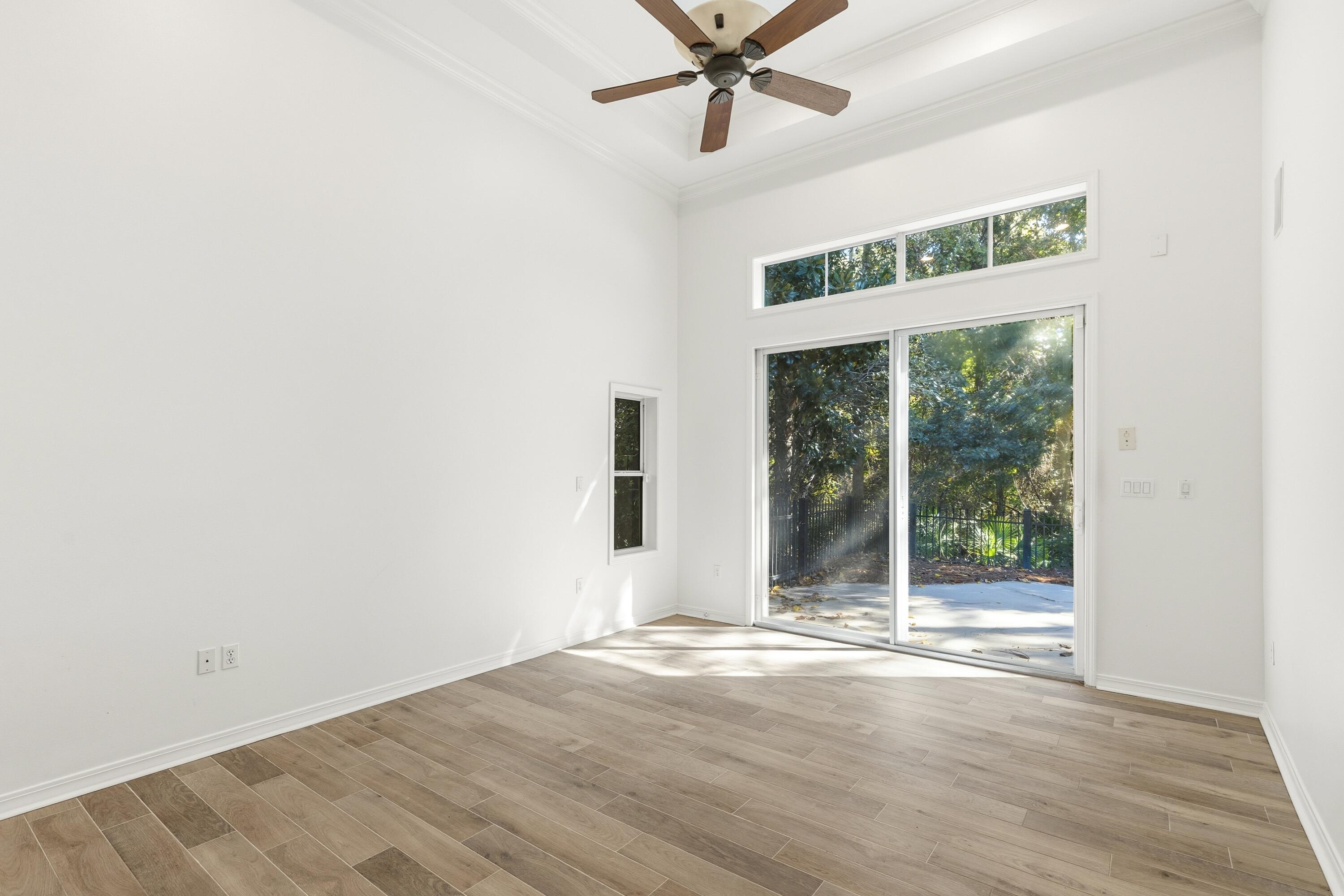 2928 Pine Valley Road Miramar Beach, FL 32550 - Photo 21 of 76 an empty room with wooden floor fan and windows