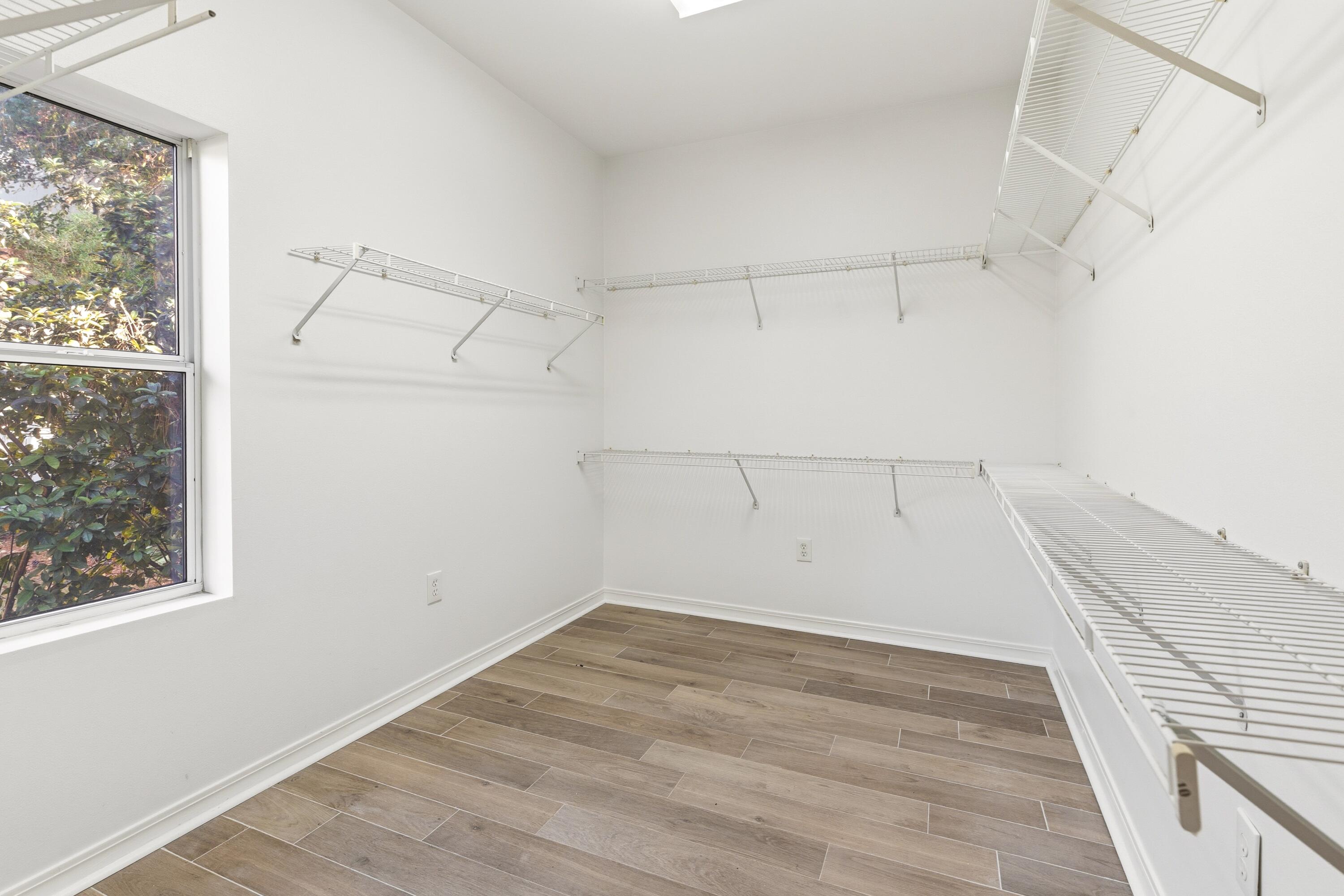2928 Pine Valley Road Miramar Beach, FL 32550 - Photo 27 of 76 an empty room with wooden floor and windows