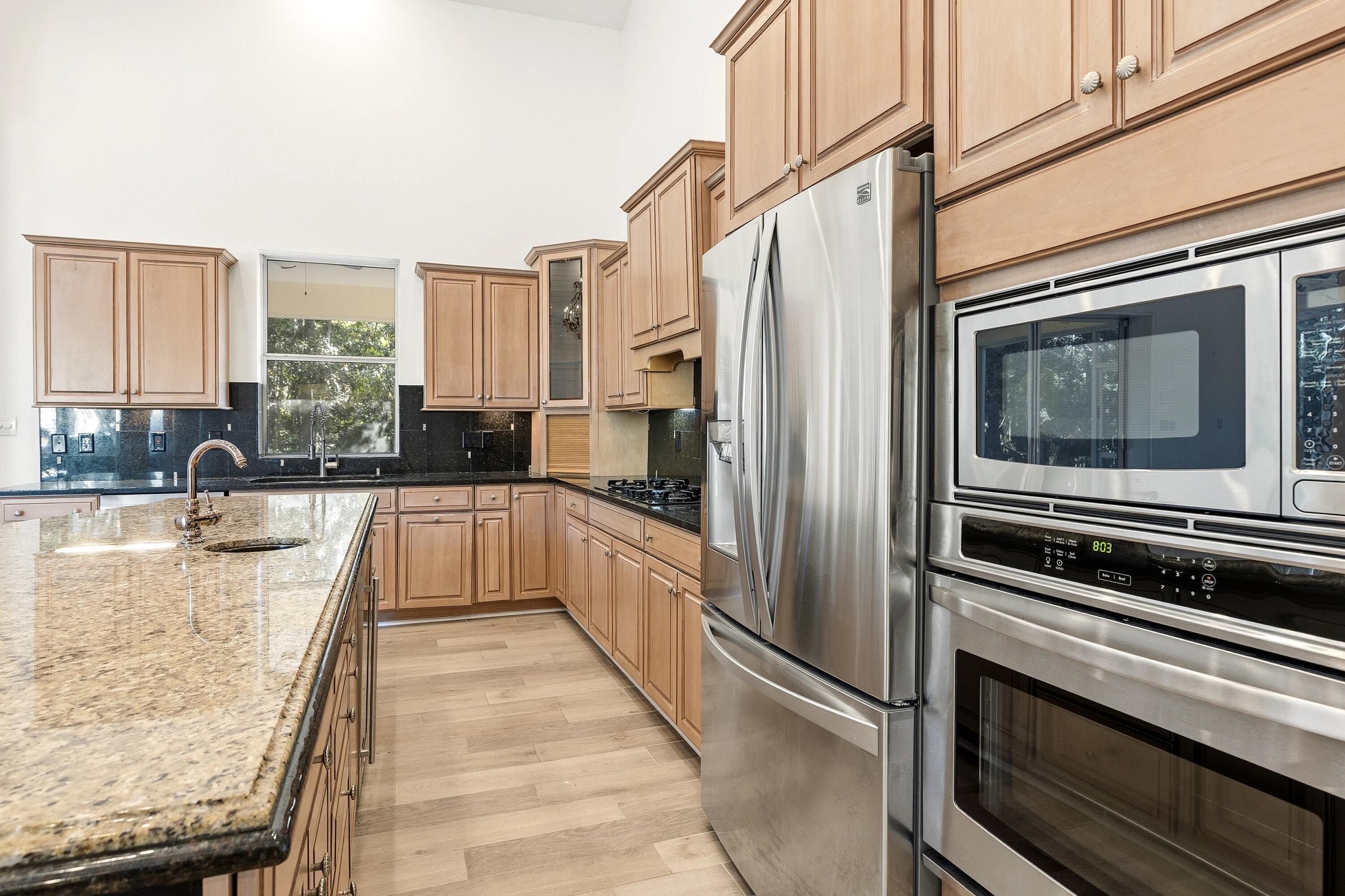 2928 Pine Valley Road Miramar Beach, FL 32550 - Photo 6 of 76 a kitchen with stainless steel appliances granite countertop a refrigerator and a stove top oven