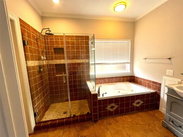 a bathroom with a tub sink and mirror