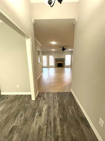 a view of a hallway with wooden floor