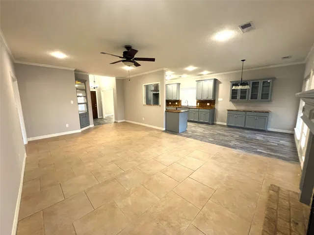 a large kitchen with cabinets and wooden floor