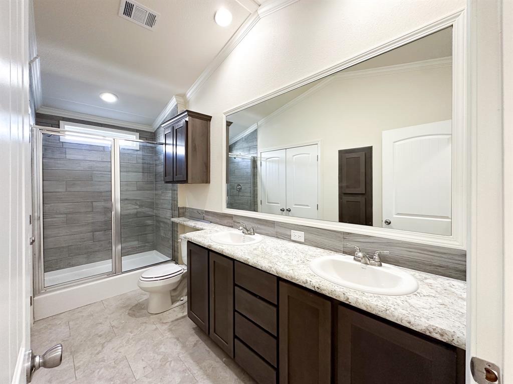 153 Cabrera Street Oak Point, TX 75068 - Photo 6 of 22 Bathroom featuring a double vanity with dark wood-finish cabinetry and light-toned countertops