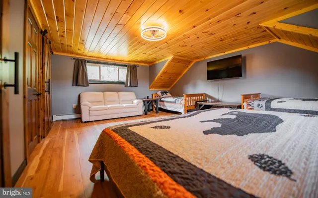 a bedroom with bed and a tv