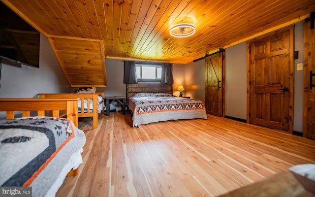 a view of a living room with furniture and a flat screen tv