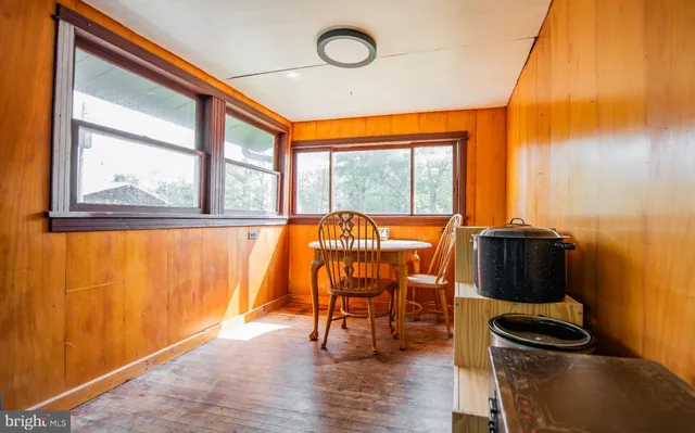 a view of a room with furniture and wooden floor