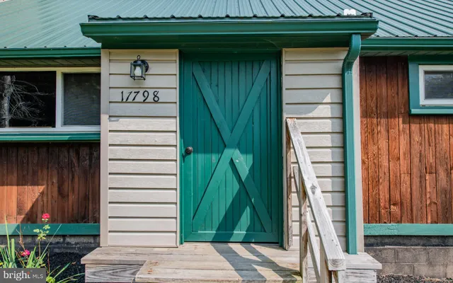 a front view of a house with a garden and plants