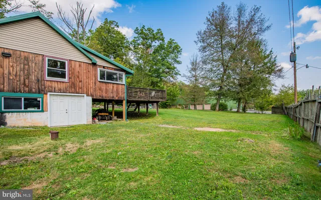 a view of a house with a yard and sitting area