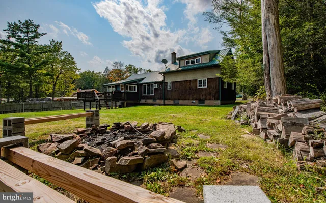 a view of a house with swimming pool and sitting area