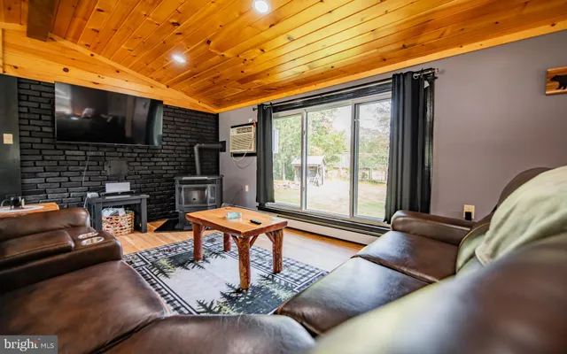 a living room with patio furniture and a fireplace