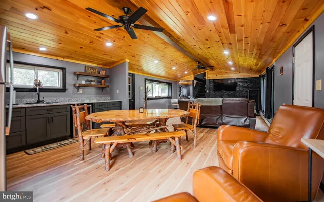 a view of a patio with dining table and chairs with wooden floor