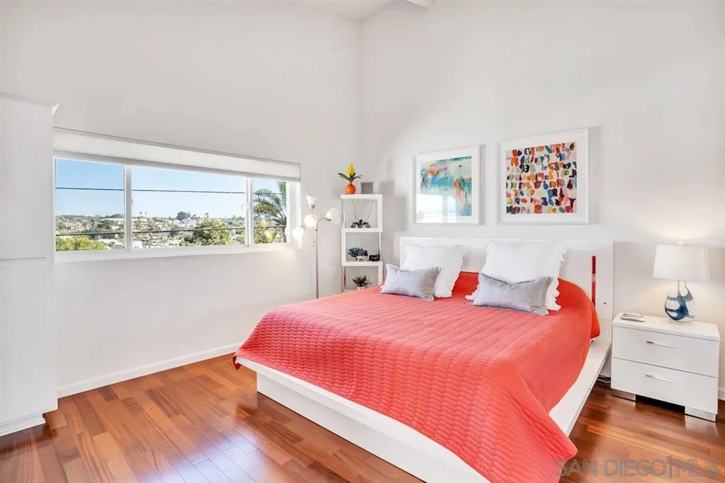 742 Neptune Avenue Encinitas, CA 92024 - Photo 11 of 25 a bedroom with a bed and a window