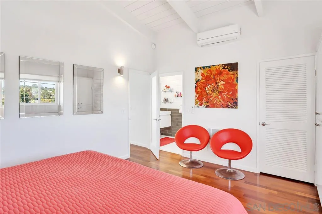 742 Neptune Avenue Encinitas, CA 92024 - Photo 12 of 25 a bedroom with a bed and a painting on the wall