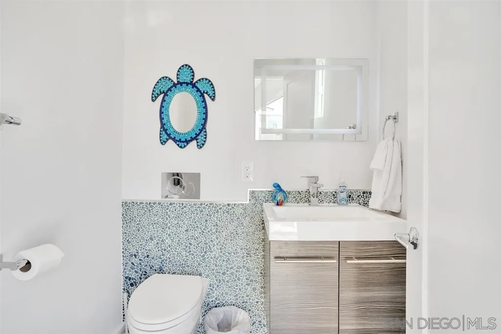 742 Neptune Avenue Encinitas, CA 92024 - Photo 19 of 25 a bathroom with a sink toilet and mirror