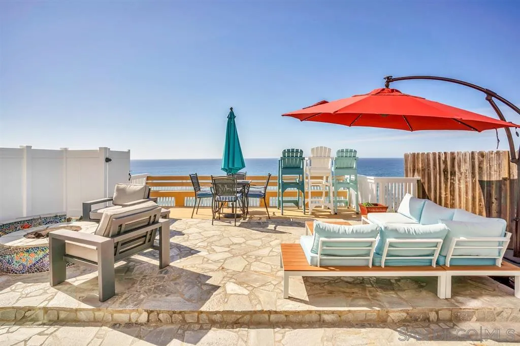 742 Neptune Avenue Encinitas, CA 92024 - Photo 4 of 25 a living room with furniture and a floor to ceiling window