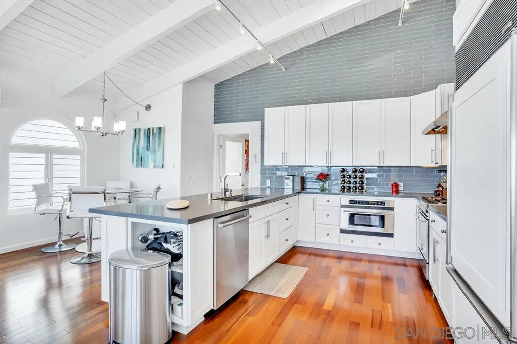742 Neptune Avenue Encinitas, CA 92024 - Photo 6 of 25 a kitchen with stainless steel appliances granite countertop a stove and cabinets