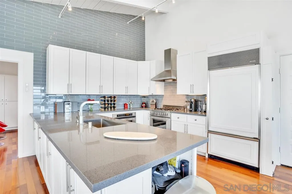 742 Neptune Avenue Encinitas, CA 92024 - Photo 10 of 25 a kitchen with stainless steel appliances granite countertop a sink a stove and refrigerator