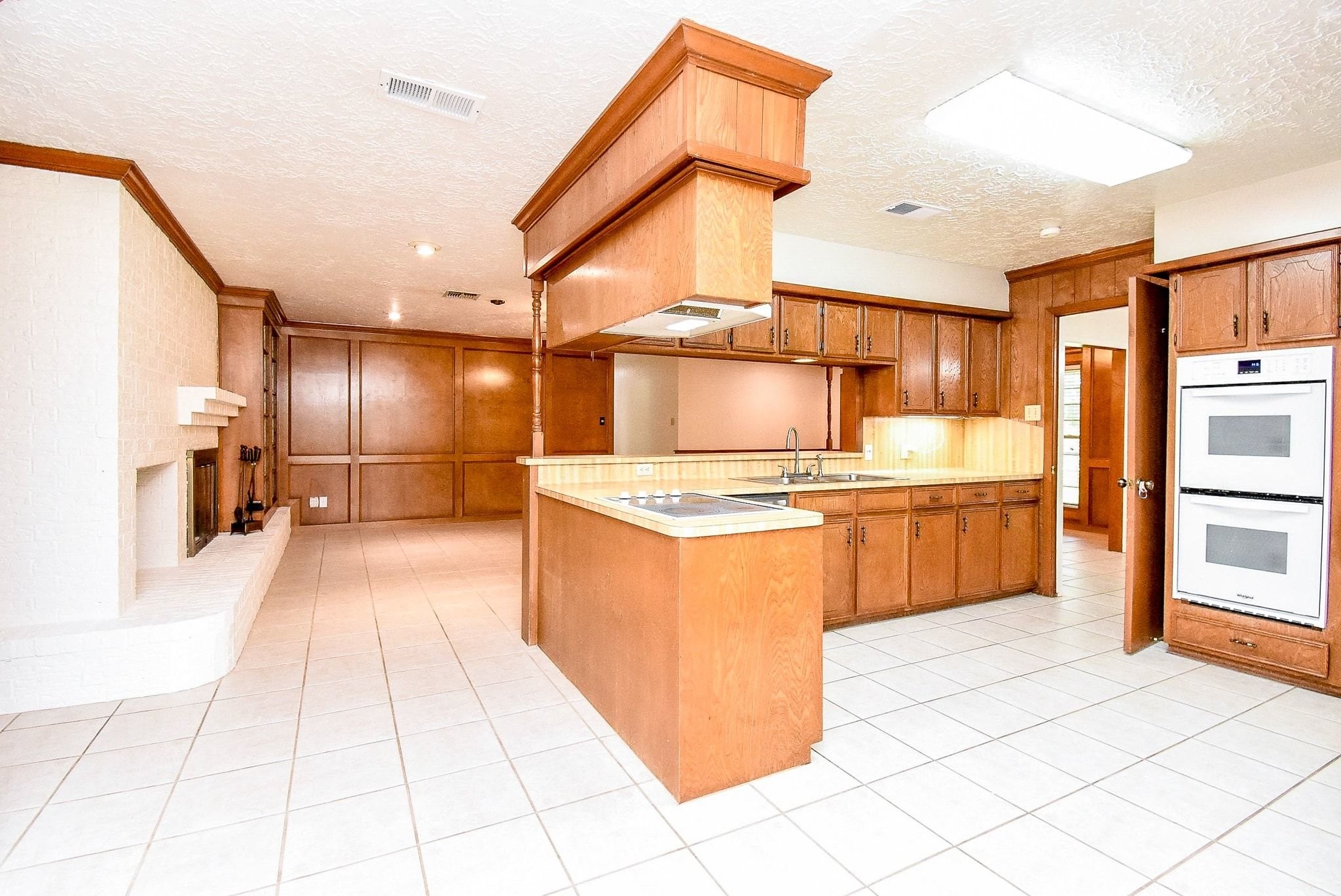 2719 Vail Road Rosenberg, TX 77471 - Photo 13 of 36 a large kitchen with stainless steel appliances kitchen island granite countertop a refrigerator and a stove top oven