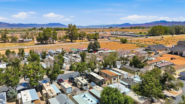 416 Kari Parowan, UT 84761 - Photo 8 of 14 Aerial perspective showcasing a community with varied housing structures, surrounded by mature trees