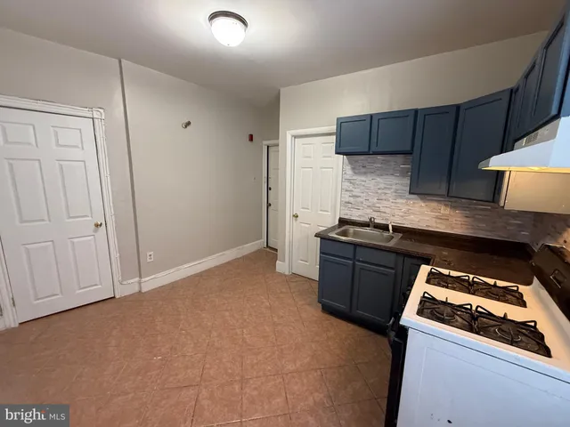 a kitchen with granite countertop a stove and a refrigerator