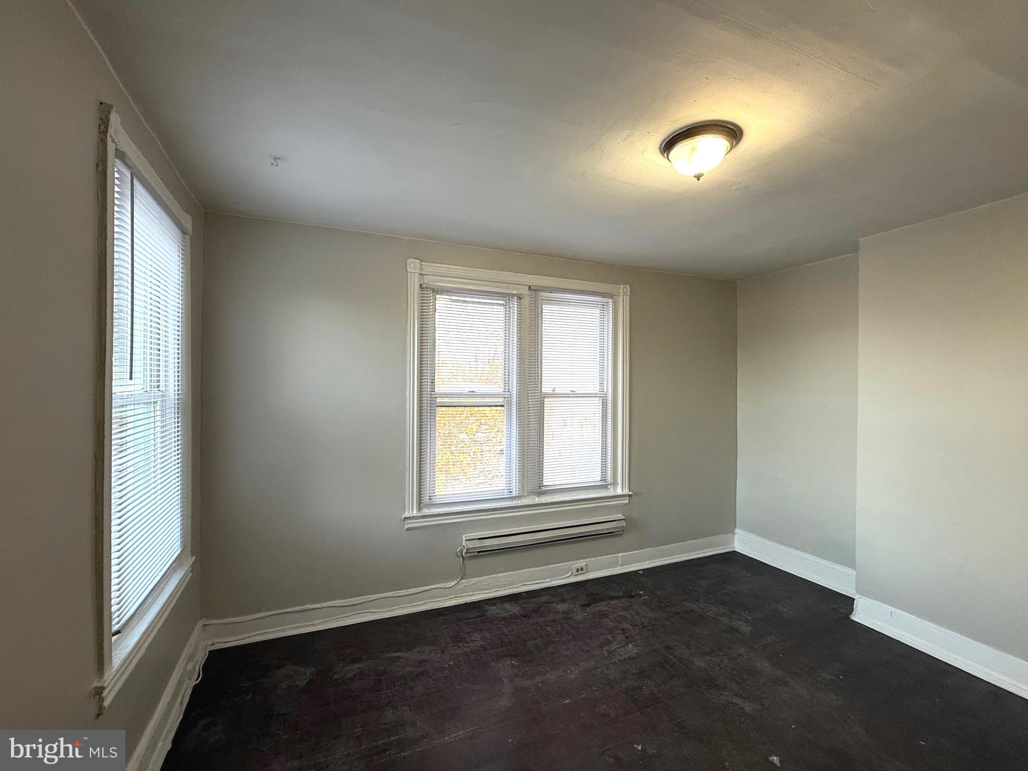 5748 Chestnut Street, Unit C Philadelphia, PA 19139 - Photo 6 of 7 an empty room with wooden floor and windows