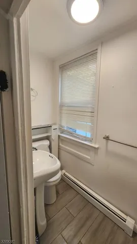 a view of an empty room and wooden floor