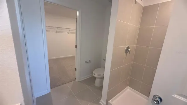 a bathroom with a sink vanity granite and shower