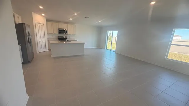 a kitchen with stainless steel appliances a refrigerator sink and cabinets