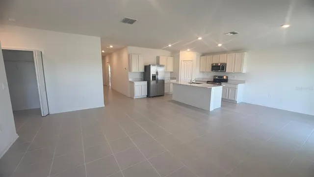 a kitchen with stainless steel appliances a refrigerator and a sink