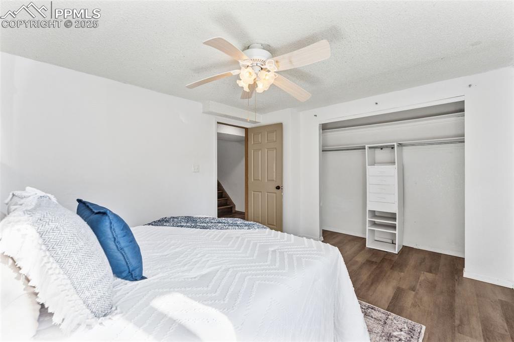 6447 Jonathan Court Colorado Springs, CO 80918 - Photo 11 of 16 a bedroom with a large bed and a chandelier