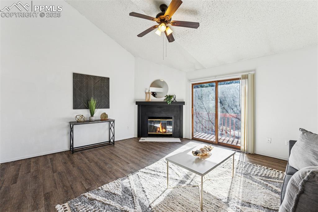 6447 Jonathan Court Colorado Springs, CO 80918 - Photo 2 of 16 a living room with furniture and a fireplace