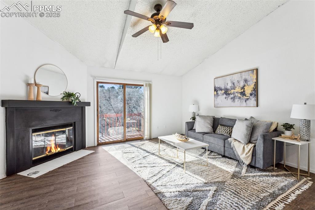 6447 Jonathan Court Colorado Springs, CO 80918 - Photo 3 of 16 a living room with furniture and a fireplace
