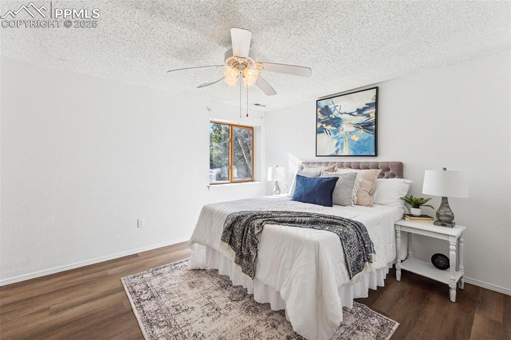 6447 Jonathan Court Colorado Springs, CO 80918 - Photo 4 of 16 a bed room with a bed and a window