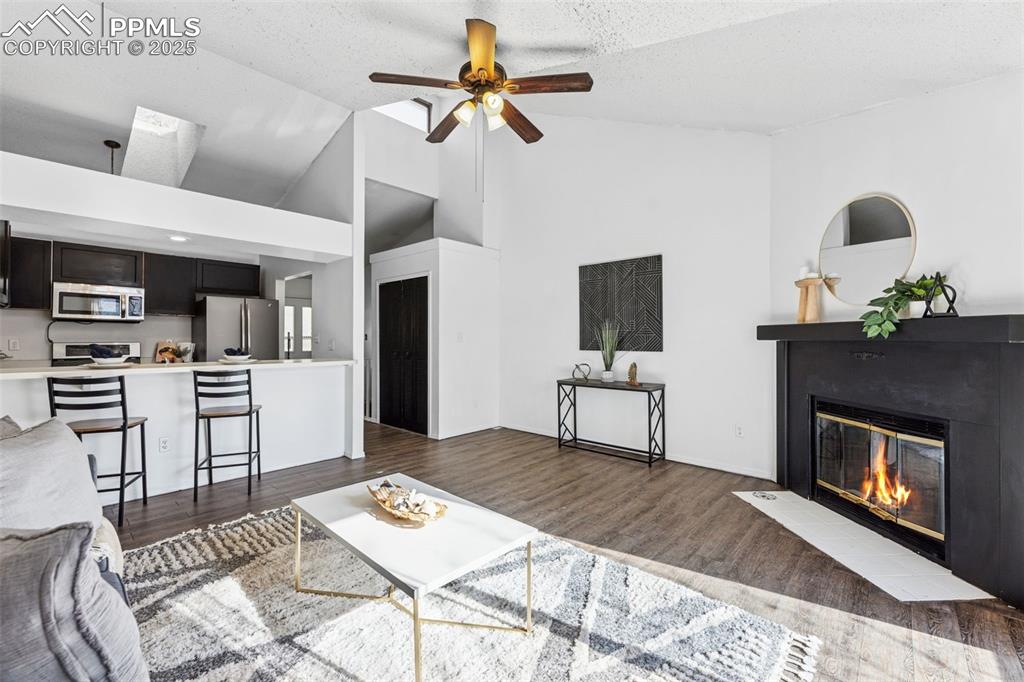 6447 Jonathan Court Colorado Springs, CO 80918 - Photo 6 of 16 a living room with furniture and a fireplace