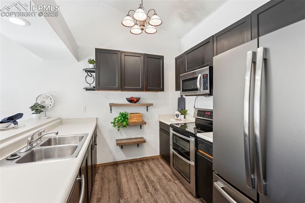 6447 Jonathan Court Colorado Springs, CO 80918 - Photo 7 of 16 a kitchen with stainless steel appliances a refrigerator sink and microwave