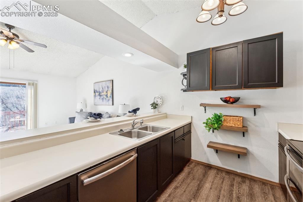 6447 Jonathan Court Colorado Springs, CO 80918 - Photo 8 of 16 a kitchen with a sink and a stove top oven with wooden floor