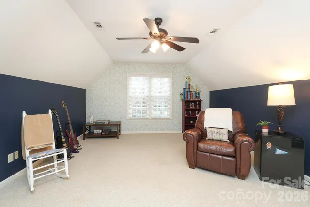 a bedroom with a bed and a chair