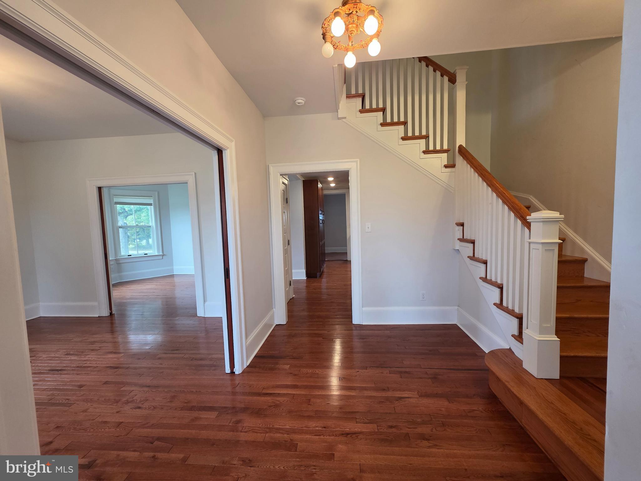1306 B Officers Row, Unit B Delaware City, DE 19706 - Photo 6 of 10 a view of a hallway with wooden floor and staircase