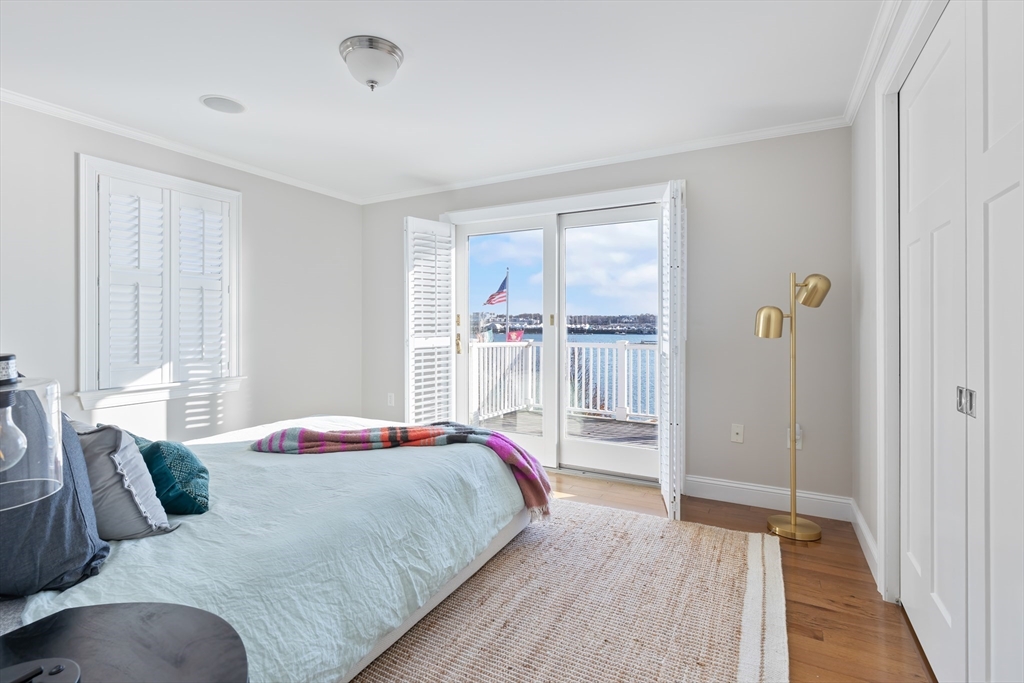 25 Bay Street Hull, MA 02045 - Photo 14 of 27 a bedroom with a balcony a bed and a window