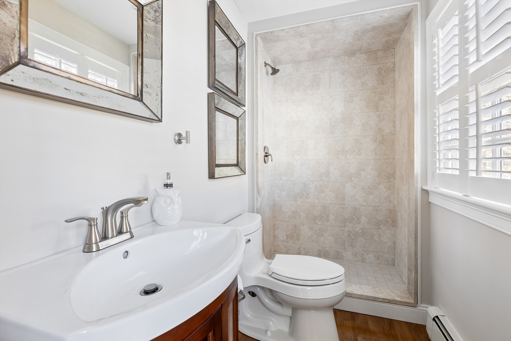 25 Bay Street Hull, MA 02045 - Photo 18 of 27 a bathroom with a sink a toilet and shower